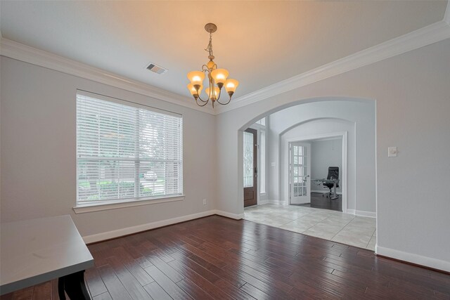 14727 Bronze Finch Dr, Cypress, TX 77433 - unfurnished dining area with a chandelier, plenty of natural light, arched walkways, crown molding, and light wood-style floors