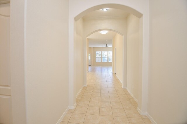 15111 Crescent Lilly Dr, Cypress, TX 77433 - hall with light tile patterned floors, ornamental molding, arched walkways, and baseboards