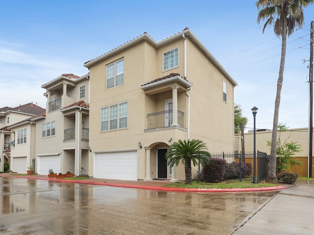 7106 Harmony Cv, Houston, TX 77036 - view of front of property featuring an attached garage, stucco siding, and a tiled roof