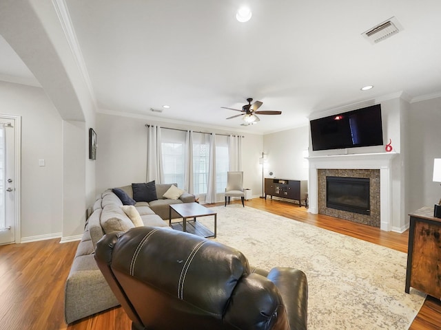 7106 Harmony Cv, Houston, TX 77036 - living area with ornamental molding, wood finished floors, ceiling fan, a fireplace, and baseboards