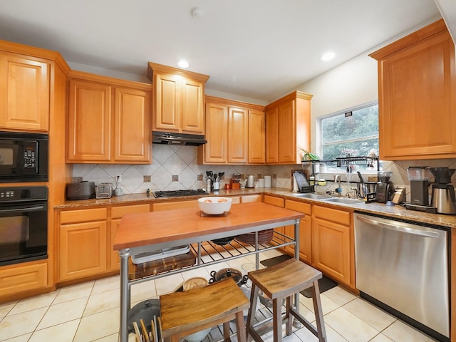 7106 Harmony Cv, Houston, TX 77036 - kitchen with black appliances, light tile patterned floors, backsplash, under cabinet range hood, and recessed lighting