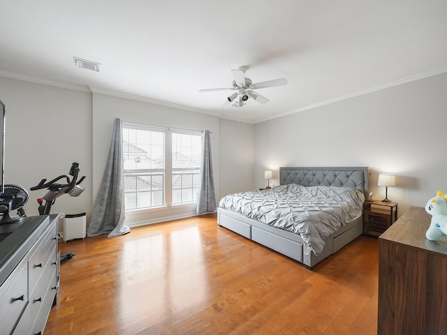 7106 Harmony Cv, Houston, TX 77036 - bedroom featuring light wood-type flooring, ornamental molding, and a ceiling fan