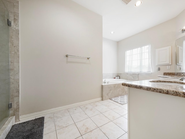 7106 Harmony Cv, Houston, TX 77036 - bathroom featuring a bath, double vanity, tile patterned floors, a stall shower, and recessed lighting