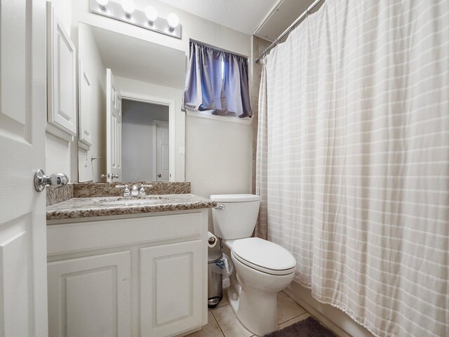7106 Harmony Cv, Houston, TX 77036 - bathroom with tile patterned flooring, toilet, vanity, and a shower with curtain