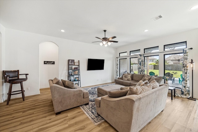 1810 Opal Field Ln, Richmond, TX 77469 - living area with arched walkways, light wood finished floors, baseboards, a ceiling fan, and recessed lighting