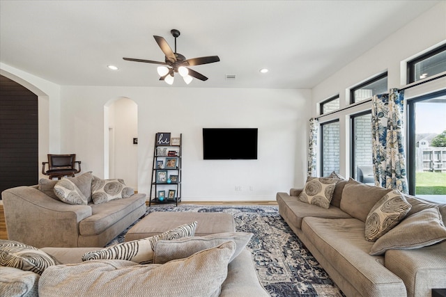 1810 Opal Field Ln, Richmond, TX 77469 - living area with arched walkways, wood finished floors, ceiling fan, and recessed lighting
