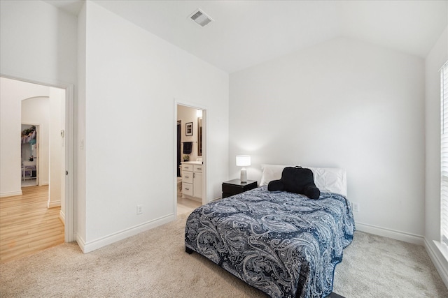 1810 Opal Field Ln, Richmond, TX 77469 - bedroom featuring light colored carpet, arched walkways, baseboards, high vaulted ceiling, and connected bathroom