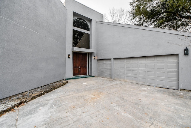 8115 Fondren Lake Dr, Houston, TX 77071 - entrance to property featuring driveway, stucco siding, and an attached garage