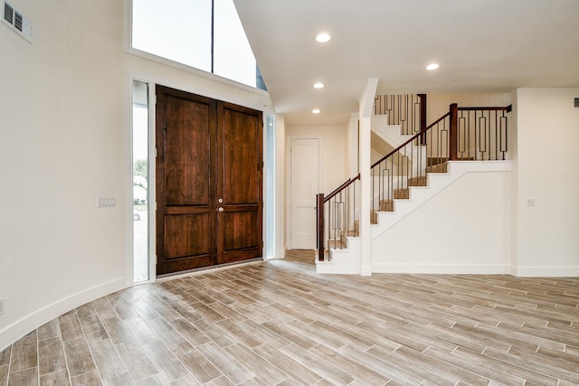 8115 Fondren Lake Dr, Houston, TX 77071 - foyer entrance featuring stairs, light wood-type flooring, plenty of natural light, a towering ceiling, and recessed lighting