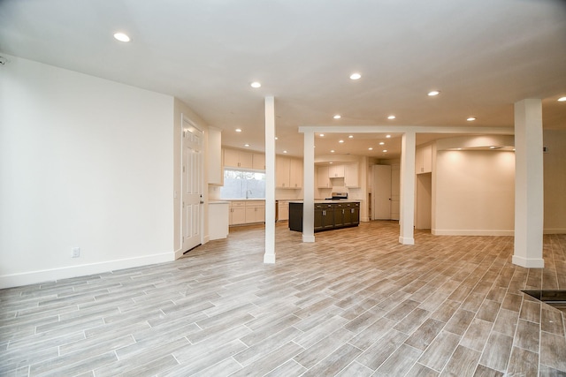 8115 Fondren Lake Dr, Houston, TX 77071 - unfurnished living room featuring a sink, recessed lighting, light wood-style floors, and baseboards