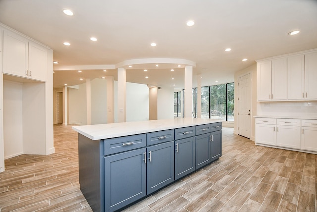 8115 Fondren Lake Dr, Houston, TX 77071 - kitchen featuring white cabinetry, recessed lighting, light wood-type flooring, a kitchen island, and floor to ceiling windows