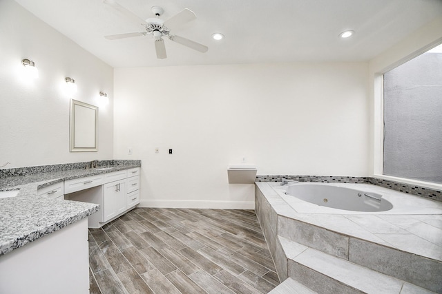 8115 Fondren Lake Dr, Houston, TX 77071 - full bath featuring vanity, a tub with jets, baseboards, a ceiling fan, and wood finished floors