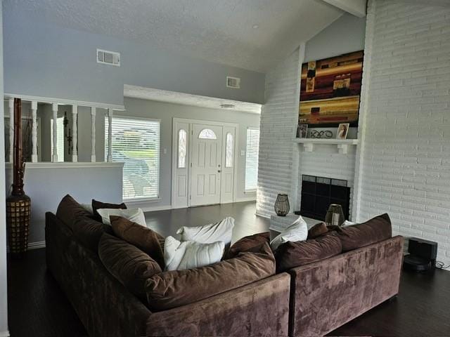3311 Oyster Cove Dr, Missouri City, TX 77459 - living room featuring dark wood-style floors, a fireplace, beamed ceiling, baseboards, and high vaulted ceiling