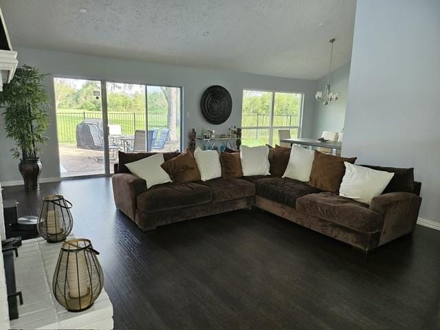 3311 Oyster Cove Dr, Missouri City, TX 77459 - living room with a chandelier, wood finished floors, baseboards, and a textured ceiling