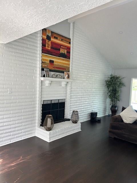 3311 Oyster Cove Dr, Missouri City, TX 77459 - living area featuring wood finished floors, a fireplace, and lofted ceiling