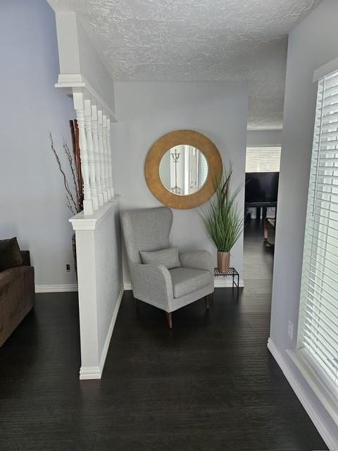 3311 Oyster Cove Dr, Missouri City, TX 77459 - sitting room featuring wood finished floors, a textured ceiling, and baseboards