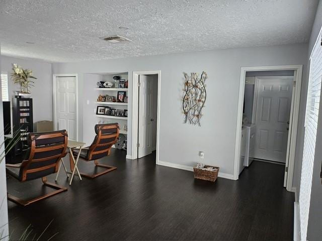 3311 Oyster Cove Dr, Missouri City, TX 77459 - living area featuring dark wood-type flooring, a textured ceiling, a desk, healthy amount of natural light, and built in shelves