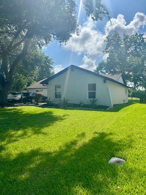 3311 Oyster Cove Dr, Missouri City, TX 77459 - view of side of home featuring stucco siding and a yard
