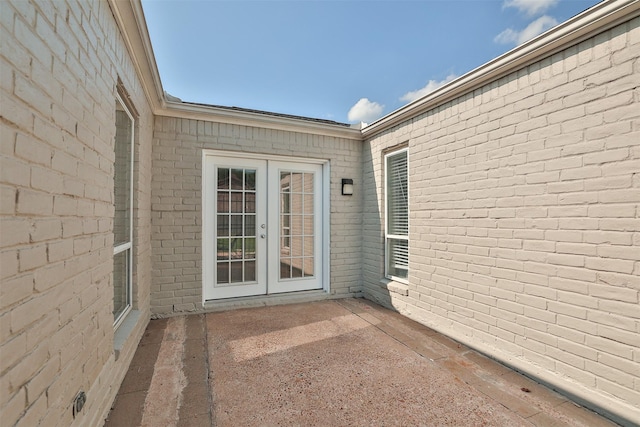 15923 Pine Mountain Dr, Houston, TX 77084 - view of exterior entry with a patio area, french doors, and brick siding