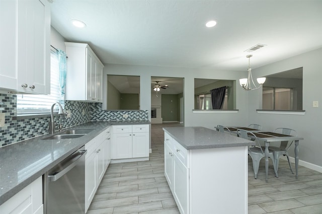 15923 Pine Mountain Dr, Houston, TX 77084 - kitchen with dishwasher, a sink, backsplash, light stone countertops, and ceiling fan
