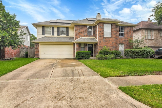 21406 Park Post Ln, Katy, TX 77450 - traditional home featuring brick siding, a garage, roof mounted solar panels, concrete driveway, and a chimney