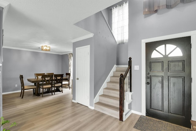 21406 Park Post Ln, Katy, TX 77450 - entrance foyer with stairway, light wood-style floors, baseboards, and crown molding