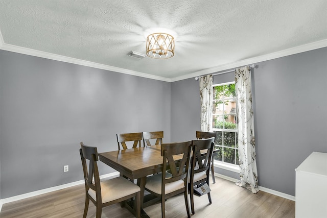 21406 Park Post Ln, Katy, TX 77450 - dining room featuring plenty of natural light, wood finished floors, a chandelier, baseboards, and a textured ceiling