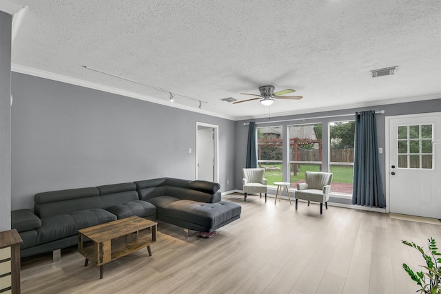 21406 Park Post Ln, Katy, TX 77450 - living room featuring ornamental molding, a textured ceiling, wood finished floors, ceiling fan, and track lighting
