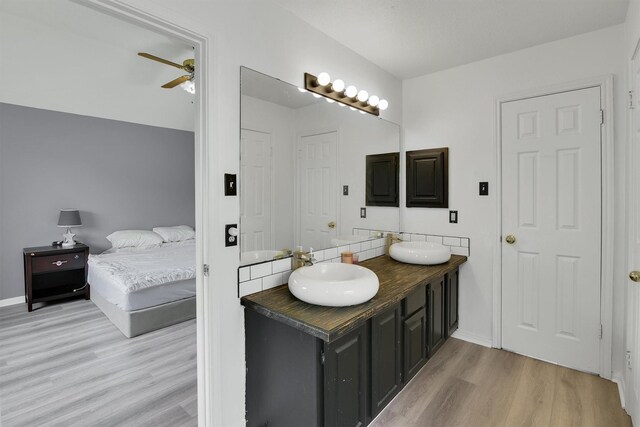 21406 Park Post Ln, Katy, TX 77450 - ensuite bathroom with wood finished floors, double vanity, ceiling fan, and baseboards