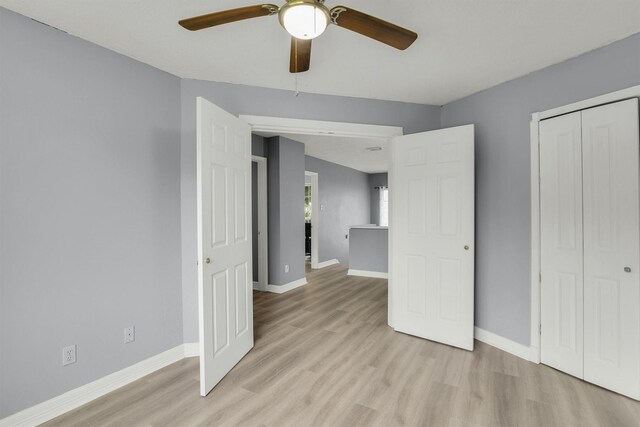 21406 Park Post Ln, Katy, TX 77450 - unfurnished bedroom with light wood-type flooring, a closet, baseboards, and a ceiling fan