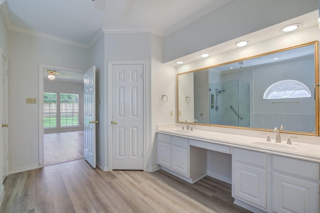 4226 Roaring Rapids Dr, Houston, TX 77059 - full bathroom featuring a stall shower, double vanity, crown molding, wood finished floors, and a ceiling fan