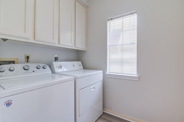 4226 Roaring Rapids Dr, Houston, TX 77059 - laundry room with washing machine and clothes dryer, cabinet space, baseboards, and wood finished floors