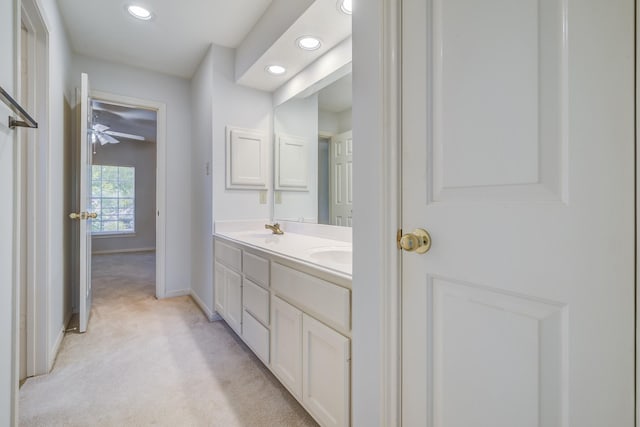 4226 Roaring Rapids Dr, Houston, TX 77059 - bathroom featuring double vanity, recessed lighting, baseboards, ceiling fan, and carpet flooring