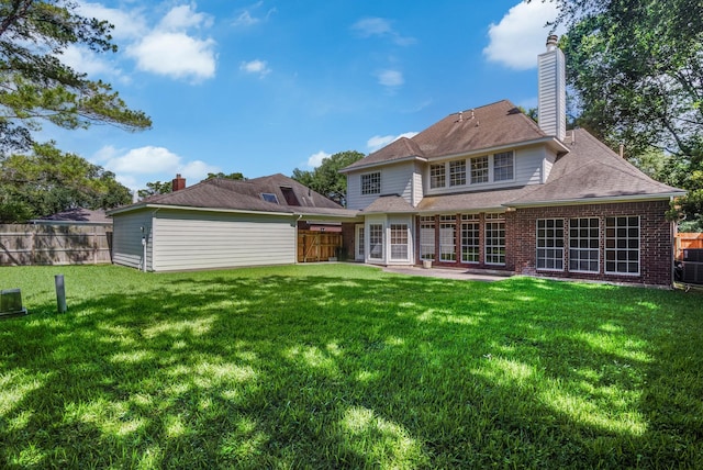 4226 Roaring Rapids Dr, Houston, TX 77059 - rear view of house featuring brick siding, a chimney, and a patio