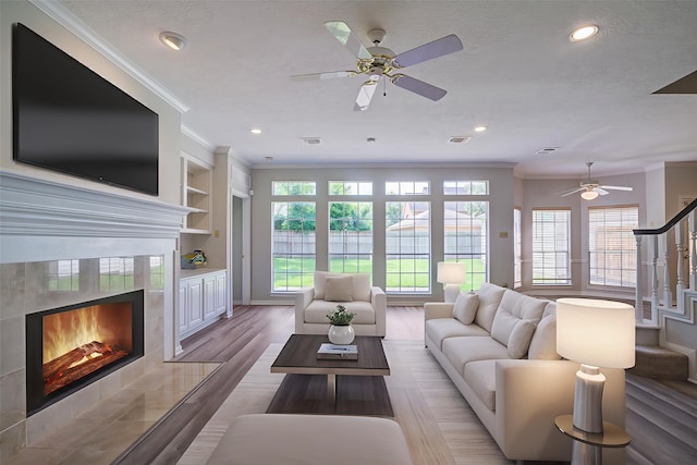 4226 Roaring Rapids Dr, Houston, TX 77059 - living room with ornamental molding, a fireplace, ceiling fan, plenty of natural light, and recessed lighting