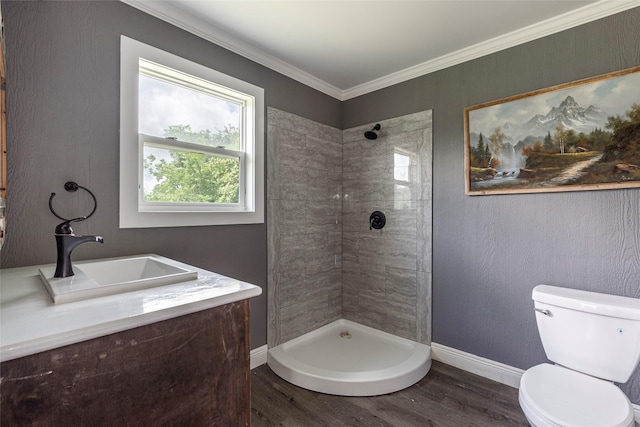 7230 Moore St, Hitchcock, TX 77563 - bathroom featuring tiled shower, wood finished floors, toilet, baseboards, and vanity