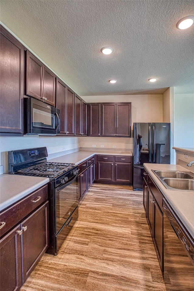 13230 Montane Manor Ln, Houston, TX 77044 - kitchen with black appliances, a textured ceiling, light countertops, dark brown cabinetry, and recessed lighting