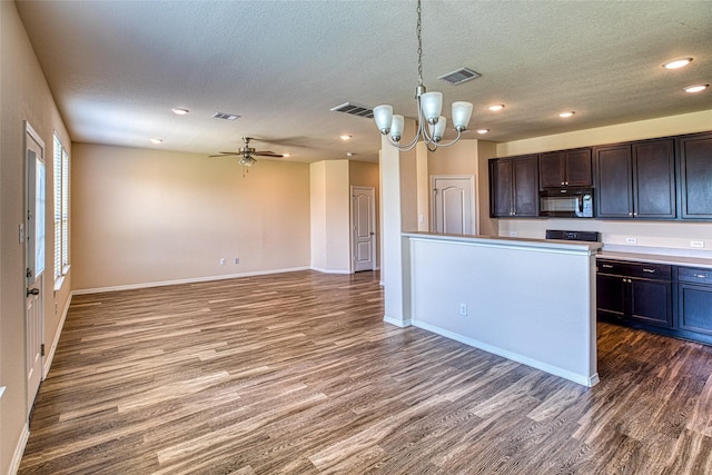 13230 Montane Manor Ln, Houston, TX 77044 - kitchen with black microwave, dark wood-style flooring, a textured ceiling, open floor plan, and recessed lighting