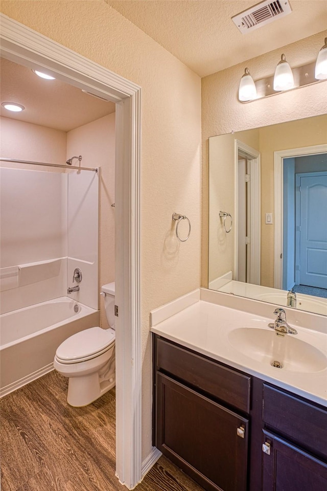 13230 Montane Manor Ln, Houston, TX 77044 - full bathroom with wood finished floors, vanity, a textured wall, shower / bathtub combination, and a textured ceiling