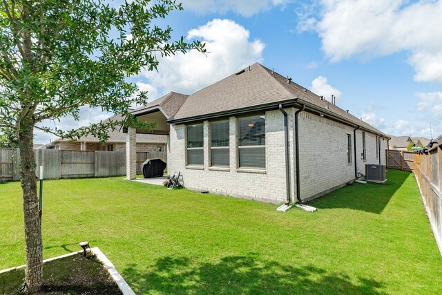 5007 Country Meadows Trl, Rosharon, TX 77583 - back of property with brick siding, roof with shingles, and central air condition unit