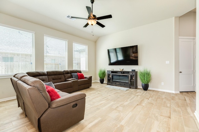 5007 Country Meadows Trl, Rosharon, TX 77583 - living room featuring ceiling fan, light wood-style floors, baseboards, and a glass covered fireplace