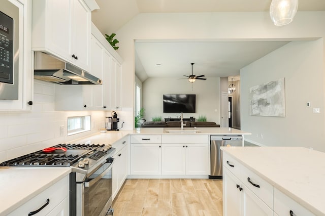 5007 Country Meadows Trl, Rosharon, TX 77583 - kitchen featuring stainless steel appliances, a sink, a ceiling fan, decorative backsplash, and open floor plan