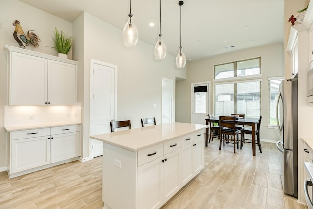 5007 Country Meadows Trl, Rosharon, TX 77583 - kitchen with freestanding refrigerator, a center island, white cabinetry, light countertops, and recessed lighting