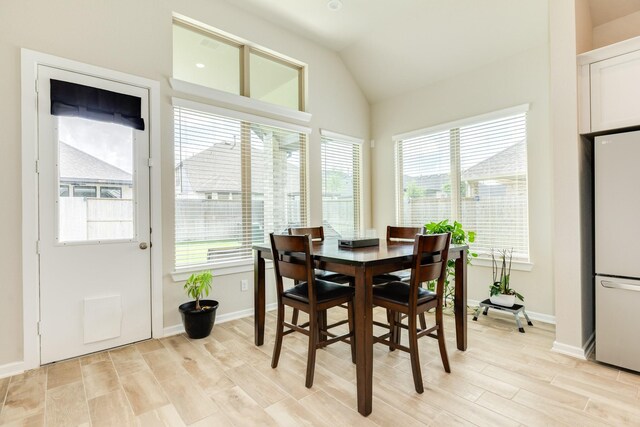 5007 Country Meadows Trl, Rosharon, TX 77583 - dining area with light wood-type flooring, lofted ceiling, and baseboards