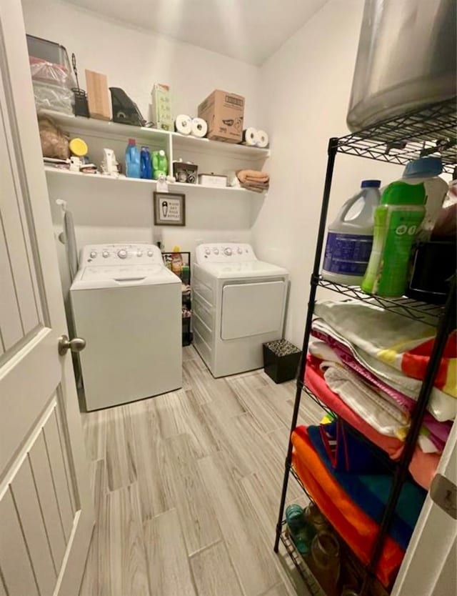 7638 Sirocco Ln, Baytown, TX 77523 - washroom featuring washer and clothes dryer and light wood-type flooring
