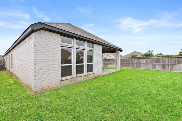 23014 Blackstone Park Rd, Katy, TX 77493 - rear view of property with brick siding, a shingled roof, and central air condition unit