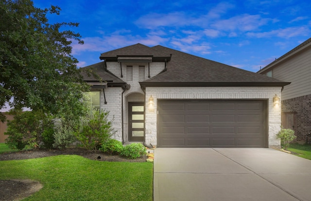 23014 Blackstone Park Rd, Katy, TX 77493 - view of front of home featuring brick siding, an attached garage, driveway, a shingled roof, and a front lawn