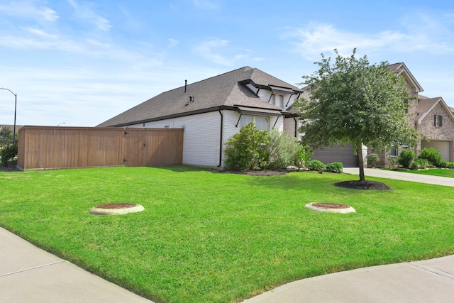 23014 Blackstone Park Rd, Katy, TX 77493 - view of home's exterior featuring brick siding, roof with shingles, and a yard