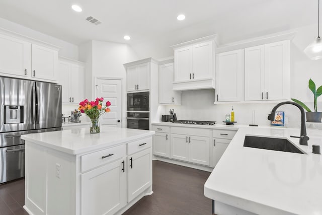 23014 Blackstone Park Rd, Katy, TX 77493 - kitchen with stainless steel fridge, oven, a sink, black microwave, and tasteful backsplash