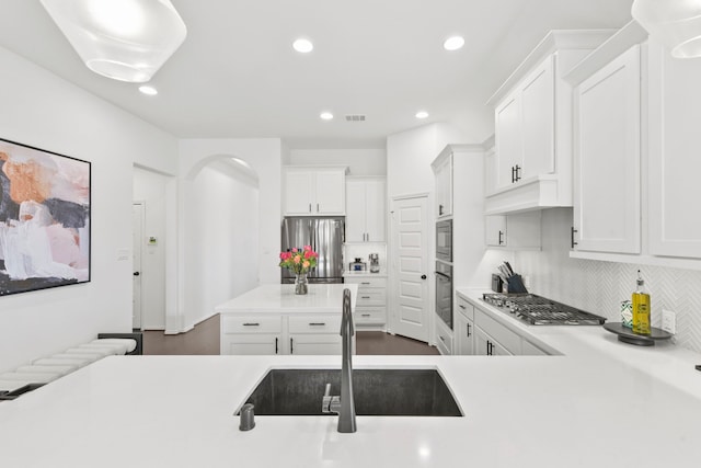 23014 Blackstone Park Rd, Katy, TX 77493 - kitchen featuring appliances with stainless steel finishes, a sink, light countertops, decorative backsplash, and white cabinets